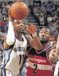  ?? NIKKI BOERTMAN / THE COMMERCIAL APPEAL ?? Grizzlies point guard Mike Conley shoots against the defense of Wizards guard John Wall on Saturday night at FedExForum. Conley scored 14 points and Wall had 18.