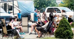  ?? ANDREW STUCKEY/Special to The Herald ?? Evacuees from the Nk’Mip Campground in Osoyoos gathered Tuesday in the parking lot of a local grocery store while figuring out where to go next.