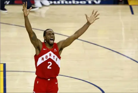  ?? Lachlan Cunningham/Getty Images ?? Kawhi Leonard celebrates the Raptors’ 114-110 win against Golden State in Game 6 of the NBA Finals Thursday night in Oakland. Attention now will quickly turn to whether Leonard will re-sign with the Raptors.