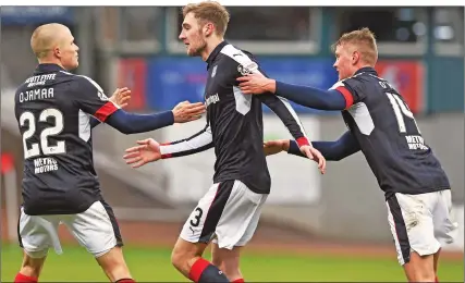  ??  ?? CENTRE OF ATTENTION: Kevin Holt is hailed by Henrik Ojamaa and Mark O’Hara after grabbing Dundee’s equaliser