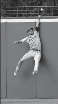  ?? The Associated Press ?? HIGHWAY ROBBERY: Tampa Bay Rays outfielder Kevin Kiermaier jumps to catch a fly ball hit by Cleveland Indians’ Jason Kipnis for the last out in the ninth inning of a 7-4 win Wednesday in Cleveland.