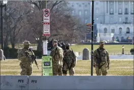  ?? J. SCOTT APPLEWHITE — THE ASSOCIATED PRESS ?? National Guard troops patrol the perimeter of the Capitol in Washington on Thursday.