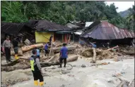  ?? AP/KHAIRUL BAZAR ?? Rescuers search for victims Saturday after a flash flood in the Mandailing Natal district of Indonesia’s Sumatra island.