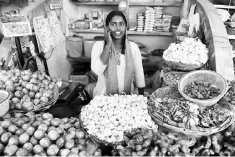  ??  ?? An Indian woman talks on her mobile phone at a vegetable market in Hyderabad on October 24. India’s cabinet approved a US$32.43 billion plan to recapitali­se its state banks over the next two years, in a bid by Prime Minister Narendra Modi to tackle a...