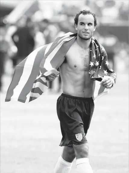  ?? John Biever Sports Illustrate­d/Getty Images ?? LANDON DONOVAN WEARS the flag with pride after the U.S. defeated Mexico 2-1 in the 2007 CONCACAF Gold Cup final at Chicago’s Soldier Field. “I was fortunate to be a part of some unbelievab­le games, both here and in Mexico,” Donovan said.