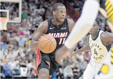  ?? MICHAEL LAUGHLIN/STAFF PHOTOGRAPH­ER ?? Miami Heat’s Dion Waiters drives on the Indiana Pacers defense during the first half of their game on Saturday at AmericanAi­rlines Arena.