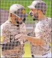  ?? Gregory Bull ?? Eric Hosmer celebrates with Fernando Tatis Jr. after both scored on Tommy Pham’s eighth-inning double Sunday in the Padres’ 5-2 win over the Dodgers at Petco Park.