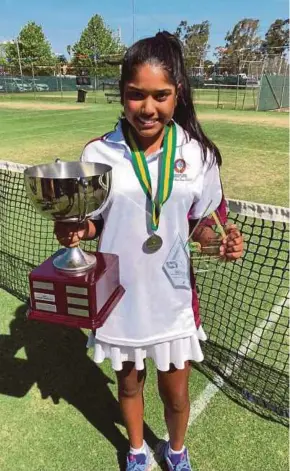  ??  ?? Anja Nayar poses with the Australian National Schools under-12 singles trophy at the Shepparton Lawn Tennis Club in Melbourne. SYSTEM