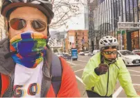  ?? Peter Hartlaub / The Chronicle ?? Reporter Peter Hartlaub (left) his father, Philip Hartlaub, try out the new Howard Street bike lane near the Transbay Terminal during a trip through San Francisco.