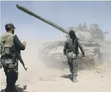  ?? AFP ?? Pro-Syrian regime forces advancing towards Douma last Saturday. The town is now reportedly under their control