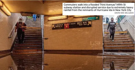  ?? DAVID DEE DELGADO ?? Commuters walk into a flooded Third Avenue/ 149th St subway station and disrupted service due to extremely heavy rainfall from the remnants of Hurricane Ida in New York City