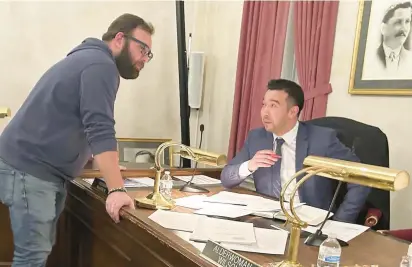  ?? ?? Calumet City Ald. James Patton, left, speaks with Ald. Michael Navarrete during Wednesday’s City Council meeting at City Hall.