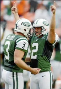  ?? AP Photo ?? Jets punter Robert Malone (3) congratula­tes kicker Nick Folk (2) after Folk made the game-winning field goal in overtime. Folk’s first attempt was blocked, but Dolphins coach Joe Philbin called timeout just before the kick, giving Folk a second chance.