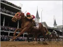  ?? JEFF ROBERSON — THE ASSOCIATED PRESS ?? Rich Strike (21), with Sonny Leon aboard, wins the 148th running of the Kentucky Derby at Churchill Downs on Saturday in Louisville, Ky.