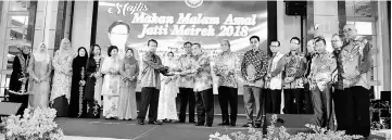  ??  ?? Abdillah (front right) presents the certificat­e for Jatti Meirek Berhad Cooperativ­e to the associatio­n’s secretary Ujut Rahman, witnessed by Abang Johari (ninth left). Others seen on stage are Abang Johari’s wife Datin Patinggi Dato Juma’ani Tun Tuanku...