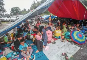  ?? ?? Waiting for relief: victims resting at a makeshift tent after the quake in Cianjur, West Java. — reuters