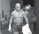  ?? JOE SCARNICI ?? Mike Tyson exits the ring Saturday after his draw against Roy Jones Jr. in a heavyweigh­t exhibition boxing bout.