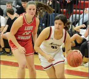  ?? Bennett Horne/McDonald County Press ?? McDonald County Lady Mustang senior Analisa Ramirez (right) drives past Reeds Spring’s Mariah Geniuk to the basket during McDonald County’s 65-31 victory in the Big 8 Conference crossover game played Monday, Feb. 13, at Mustang Arena.