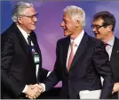  ?? JACQUELYN MARTIN / AP ?? Former President Bill Clinton shakes hands with former UAW President Owen Bieber in 2012.