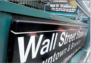  ?? AP file photo ?? The Wall Street subway stop in New York’s Financial District is shown in 2014. The stock market tumbled in trading Wednesday, adding to its worst month in two years.