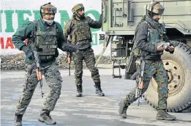  ?? Picture: YOUNIS KHALIQ/REUTERS ?? HITTING BACK: Indian soldiers at the site of a gun battle between suspected militants and Indian security forces in Pinglan village in south Kashmir’s Pulwama district on Monday