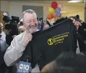  ?? Rich Pedroncell­i Associated Press ?? RICKY LEO DAVIS holds up a shirt with the Innocence Project logo after he was released Thursday.