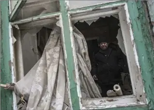  ?? EVGENIY MALOLETKA, THE ASSOCIATED PRESS ?? A man stands in his house damaged by shelling in Avdiivka, eastern Ukraine, Thursday.