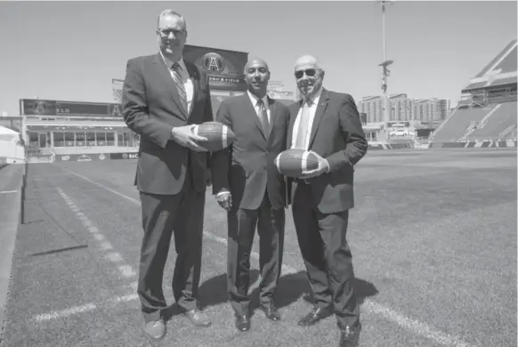  ?? BERNARD WEIL/TORONTO STAR ?? Bell Canada CEO George Cope, CFL commission­er Jeffrey Orridge and MLSE chair Larry Tanenbaum at BMO Field. The Argos announced Wednesday the team’s sale to Bell and Tanenbaum.
