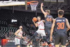  ?? COLE COOPER/TBT ?? The Enchantmen­t’s Anthony Mathis makes a move to the basket in the face of defensive pressure from the Stillwater Stars on Saturday. He scored 16 points in the game.