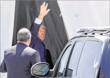  ??  ?? President Donald Trump waves as he exits Bethesda-by-the-Sea Episcopal Church in Palm Beach on Sunday after attending Easter services. Most of the congregati­on appeared not to be distracted by the president sitting in the pews.