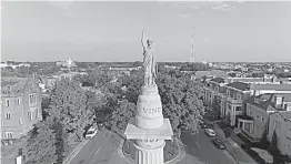  ?? AP Photo/DroneBase ?? This Aug. 22 photo shows a view of the Confederat­e President Jefferson Davis statue on Monument Avenue in Richmond, Va. Some of the oldest and largest Confederat­e statues in the U.S. tower over Monument Avenue, a four-lane road.