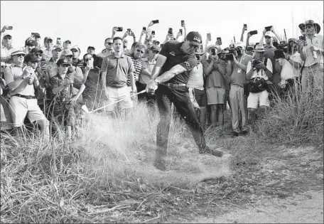  ?? David J. Phillip Associated Press ?? THEY HAD TO MOVE a golf cart so Phil Mickelson could hit his second shot on the 16th hole at the Ocean Course at Kiawah Island, S.C.. After playing flawless golf early, Mickelson had a few adventures on the back nine but still has a one-shot lead after 54 holes.