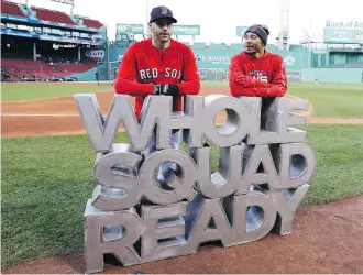  ?? ELISE AMENDOLA/THE ASSOCIATED PRESS ?? Boston Red Sox sluggers J.D. Martinez, left, and Mookie Betts are ready to go as the sign says for what promises to be a vintage World Series against the Los Angeles Dodgers.