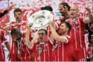  ?? With’. Photograph: Christian Bruna/EPA ?? Philipp Lahm and Xabi Alonso lift the 2017 Bundesliga trophy together at Bayern Munich. ‘Xabi was wonderful to talk shop