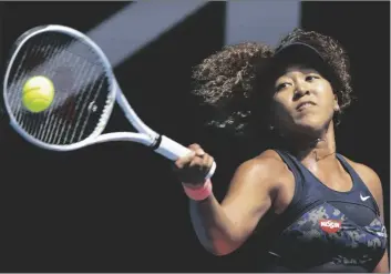  ?? ASSOCIATED PRESS ?? JAPAN’S NAOMI OSAKA HITS A FOREHAND RETURN to Taiwan’s Hsieh Su-wei during their quarterfin­al match at the Australian Open championsh­ip in Melbourne, Australia, on Tuesday.