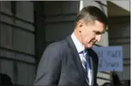  ?? SUSAN WALSH - THE ASSOCIATED PRESS ?? Former Trump national security adviser Michael Flynn leaves federal court in Washington, Friday. Flynn pleaded guilty Friday to making false statements to the FBI, the first Trump White House official to make a guilty plea so far in a wide-ranging...