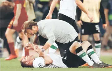  ?? — AFP photo ?? Liverpool manager Jurgen Klopp celebrates with James Milner, who scored an own goal earlier in the game, at the end of the UEFA Champions League semi-final second leg match against AS Roma at the Olympic Stadium in Rome.