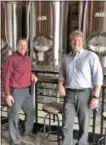  ?? PHOTO BY GLENN GRIFFITH ?? Chris Crounse and Darren Van Heusen, left and right, founders and co-brewers of the Hank Hudson Brewing Company in Halfmoon, stand in front of some of the brew pub’s equipment.