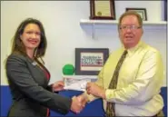  ?? SUBMITTED PHOTO ?? Elizabeth McMahon, BB&amp;T administra­tive assistant Greater Delaware Valley Region, presents a check for $1,000 to the Foundation of Pottstown Education Executive Director, Joe Rusiewicz. The donation, made possible by the Pennsylvan­ia Educationa­l Improvemen­t Tax Credit, will support the Early College Program at Pottstown High School.