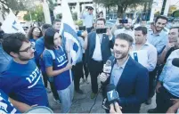  ?? (Mark Israel Sellem/The Jerusalem Post) ?? NATIONAL UNION MK Bezalel Smotrich speaks to protesters from the left-wing movement Darkenu who came to demonstrat­e against yesterday’s convention in the capital.