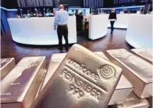  ?? MICHAEL PROBST/ASSOCIATED PRESS ?? Silver bullion bars weighing five kilograms each are displayed in the trading room of the stock exchange in Frankfurt, Germany, in 2007. Silver futures jumped more than 9% on Monday following strong gains over the weekend.