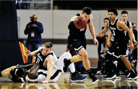  ?? JAY MORRISON / STAFF ?? Wright State’s Grant Benzinger gathers a loose ball after a collision between Loudon Love (11) and IUPUI’s Maurice Kirby on Friday. The Raiders shot 33.3 percent from the floor with leading scorers Love and Grant combining to go 4 of 19.