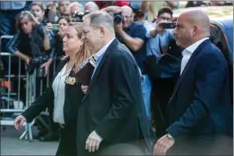  ?? Bloomberg photo by Michael Nagle ?? Harvey Weinstein, center, arrives at the New York Police Department 1st Precinct in New York on Friday.
