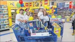  ?? SAM MCNEISH/THE TELEGRAM ?? Nathan Gibbons stands in one of the shopping carts he filled with toys during the Starlight Foundation’s 3-Minute Dash he participat­ed in on Tuesday morning at Toys ‘R’ Us. Joining Nathan in celebratin­g his accomplish­ment were members of his family,...