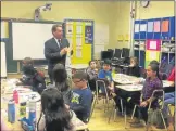  ?? NICHOLAS BUONANNO — MEDIANEWS GROUP FILE ?? East Greenbush Central School District Superinten­dent Jeffrey Simons visits with a thirdgrade class at Genet Elementary School in 2017.