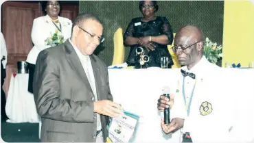  ??  ?? Bank of Zambia governor, Danny Kalyalya (left) sharing a light moment with District 413 governor, Dr Mangani Banda during the installati­on dinner of new cabinet officers for the Lionistic year 2018/19. Dr Kalyalya pledged to help the Lions with the...