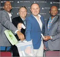  ??  ?? LUCKY DRAW: Internal audit officer Xolela Mooi, left, Enterprise Outsourcin­g Holdings local director Danie de Lange, finance political head Retief Odendaal and revenue management and customer care director Mbuzeli Nogqala choose the winners