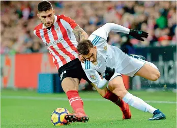  ?? AFP ?? Athletic Bilbao’s defender Unai Nunez (left) challenges Real Madrid’s forward Borja Mayoral during their Spanish league football match at the San Mames stadium in Bilbao on Saturday. Bilbao hold Real goalless. —