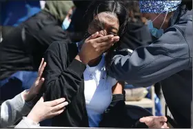  ?? (AP/Jessica Hill) ?? East Hartford High School senior Nikela Walker reacts Monday to a vaccinatio­n from nurse Dalila Perez during a mass vaccinatio­n at Pratt & Whitney Runway in East Hartford, Conn.