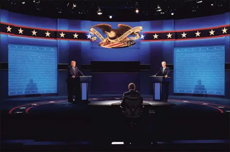  ?? Patrick Semansky / Associated Press ?? Moderator Chris Wallace of Fox News listens as President Donald Trump and former Vice President Joe Biden participat­e in the first presidenti­al debate Tuesday at Case Western University and Cleveland Clinic in Ohio.